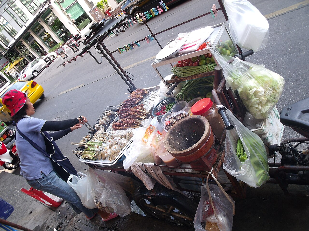 Street food vendor preparing dishes at a stall in Bangkok, Thailand photo_0