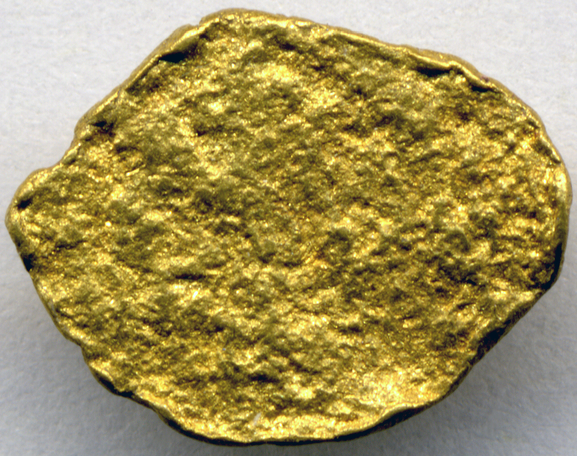 Close-up of a small natural placer gold nugget about twelve millimetres across photo_0